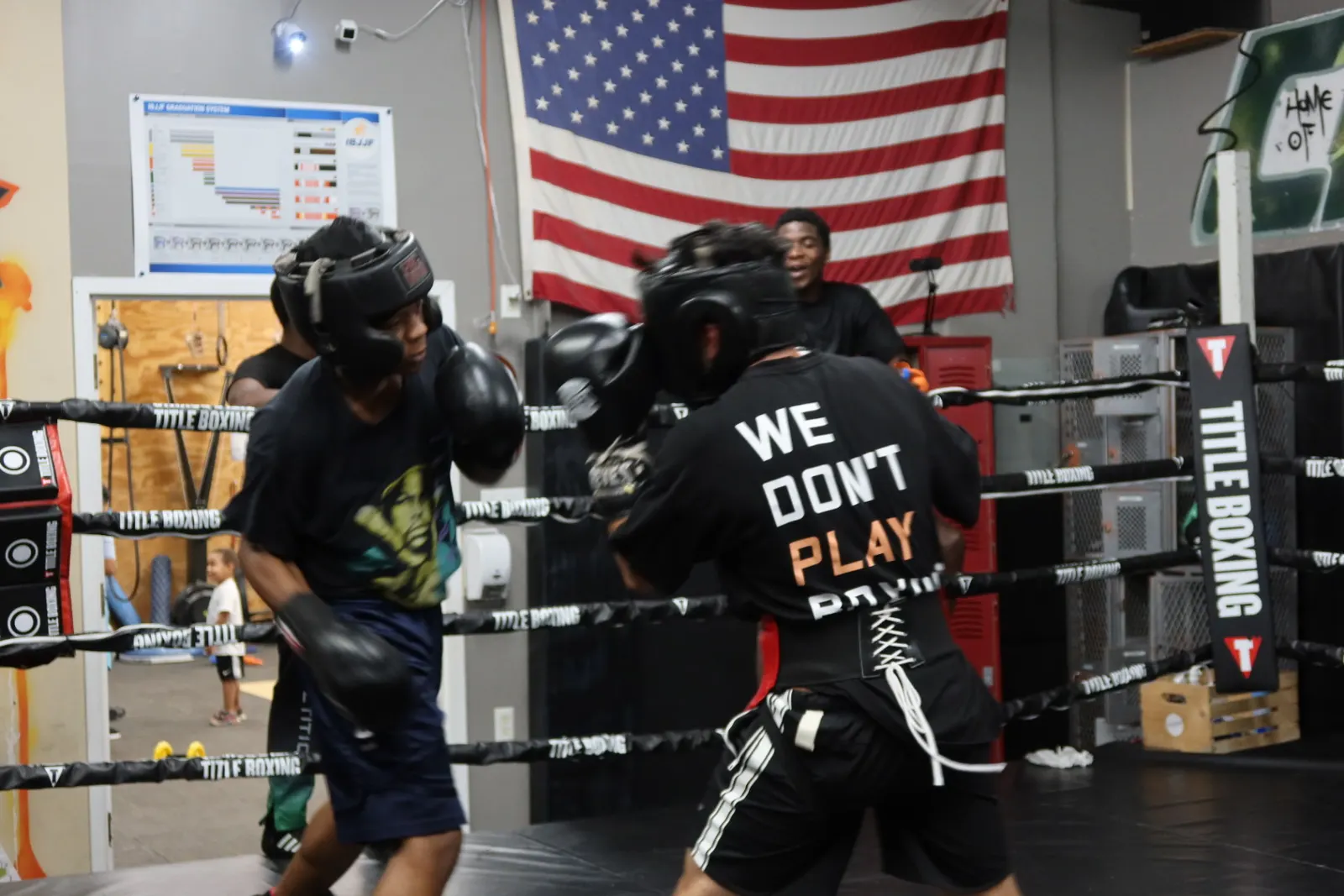 Two boxers sparring in front of an American flag