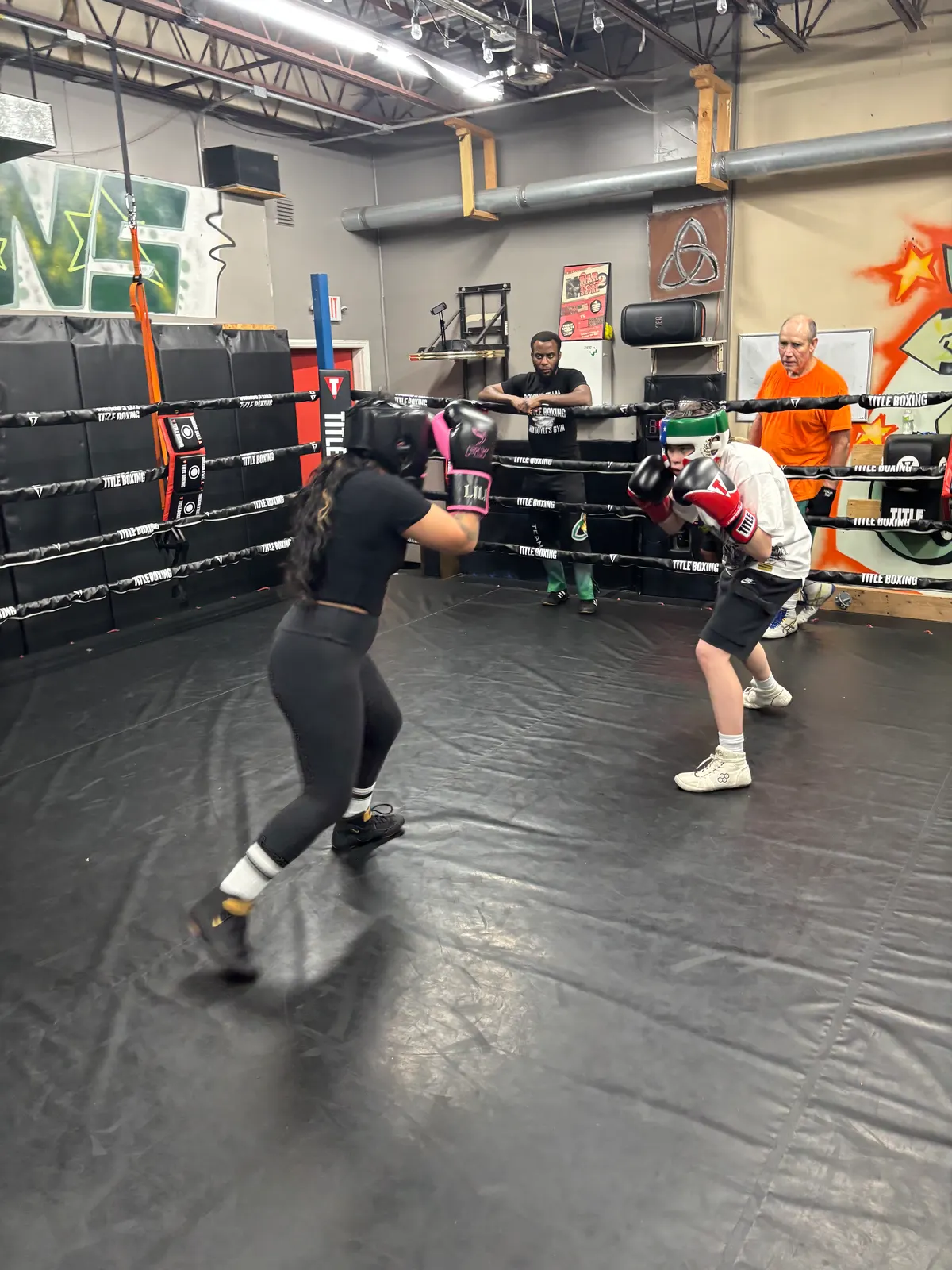 Boxers sparring on the gym mats
